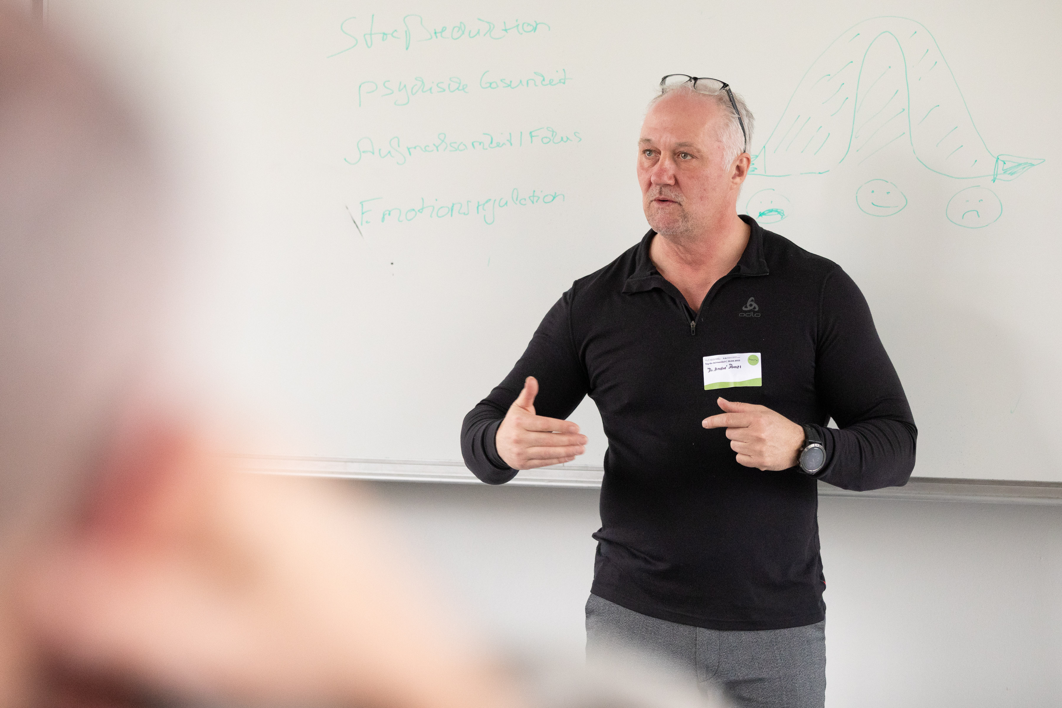 Dr. André C. Dennes lehrt vor Studierenden – Whiteboard mit SET-Themen: Stressreduktion, Fokus, Emotionsregulation